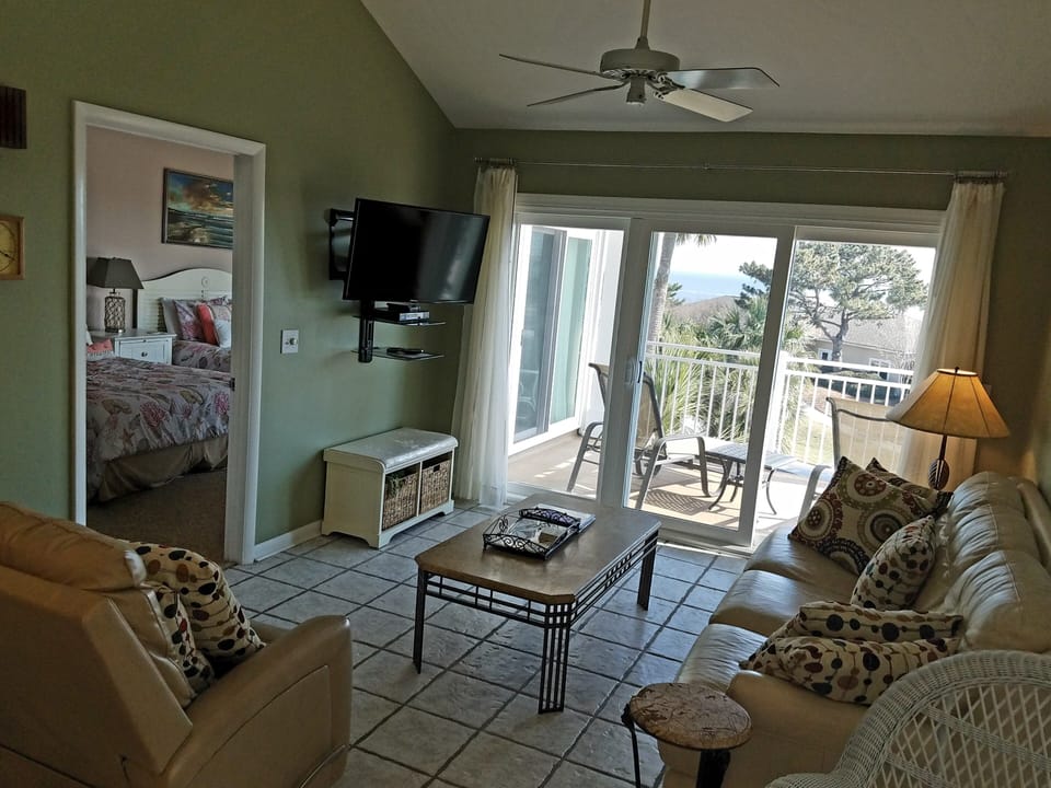 Spacious living area with access to ocean view patio 