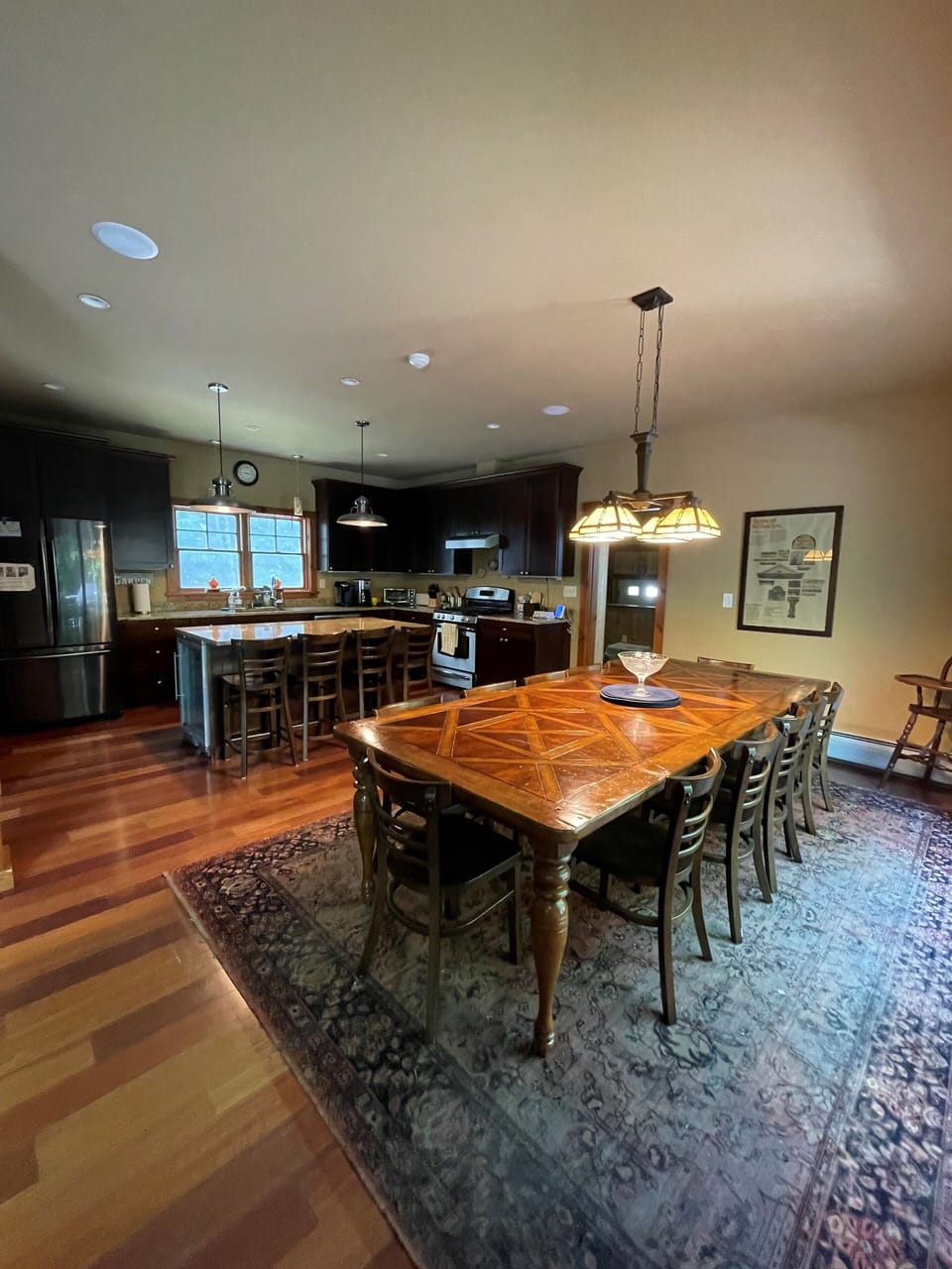Dining and kitchen. Sit 10 at table; 4 at island. 4 topper around the corner.
