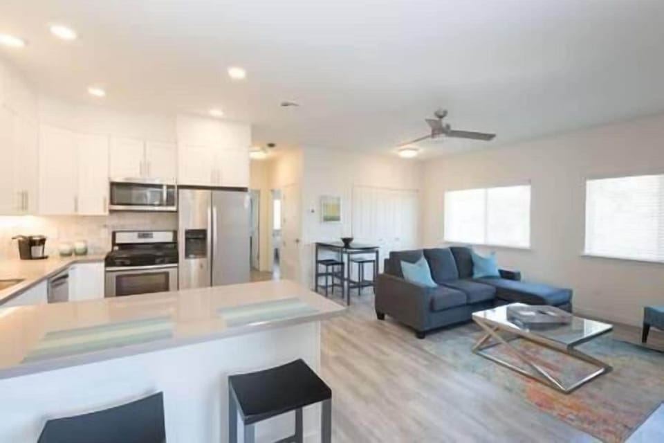 Enter a vibrant living space with fully equipped kitchen, seamlessly connected to bedrooms and bath