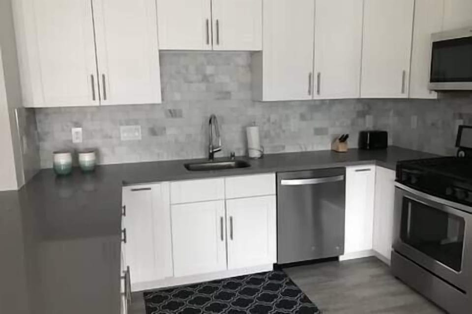 Fully-stocked kitchen with gas stove, oven, microwave, dishwasher, and Keurig, perfect for cooking.