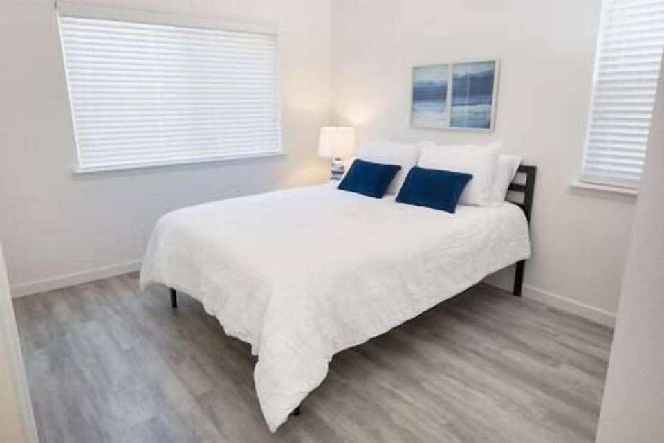 Bedroom 1 features a queen bed and serene olive orchard views, with a chance to spot wild turkeys.