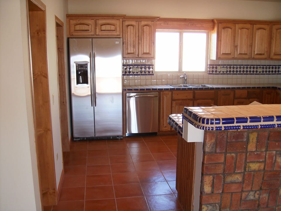 Kitchen.  Bar area has bar stools for additional seating. 