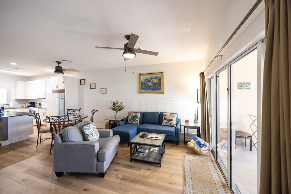 Living room with large siding doors for unencumbered pool and beach views