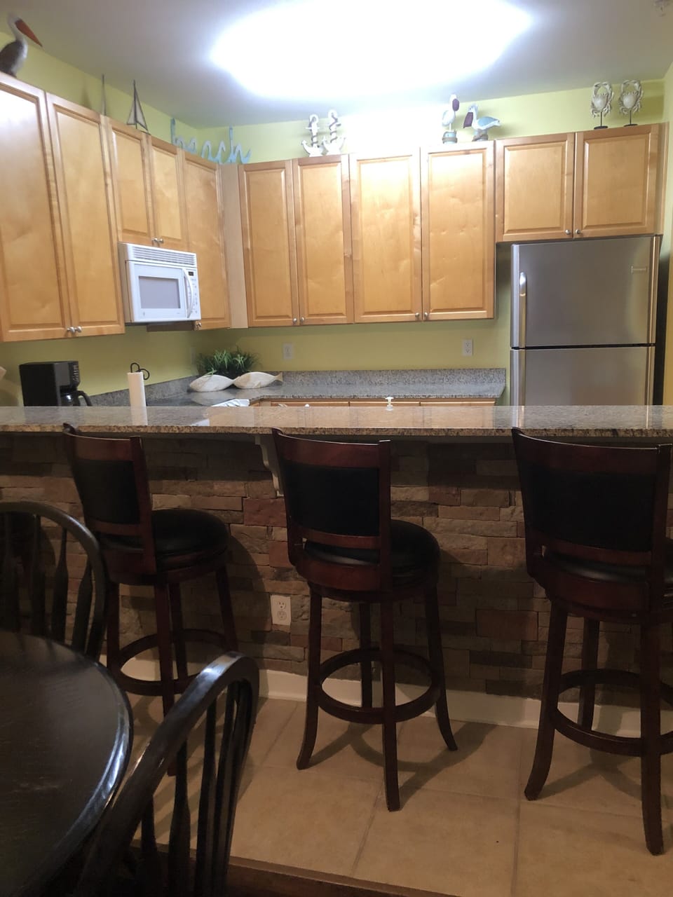 Bar seating next to dining table/kitchen area