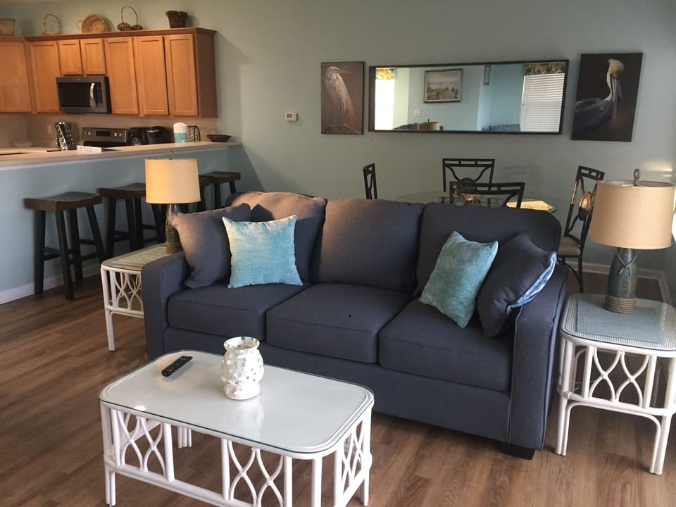 Spacious living room. New couch, loveseat, captains chair, bar stools, & TV. 
