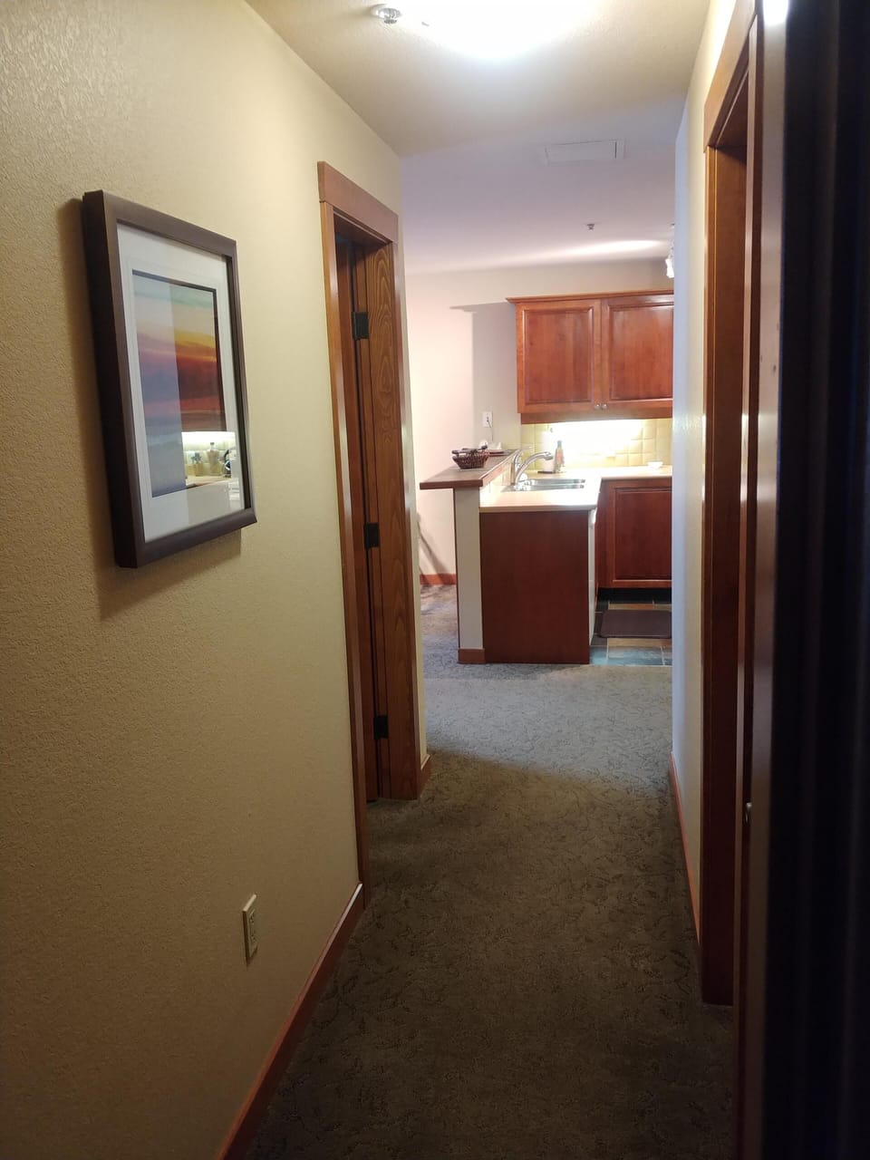 Hallway connecting kitchen, master bedroom, and bedroom suite.