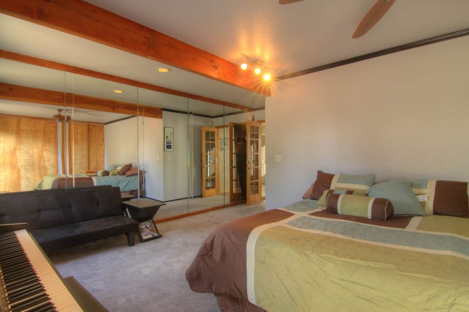 Big downstairs bedroom with one wall of mirrors. 