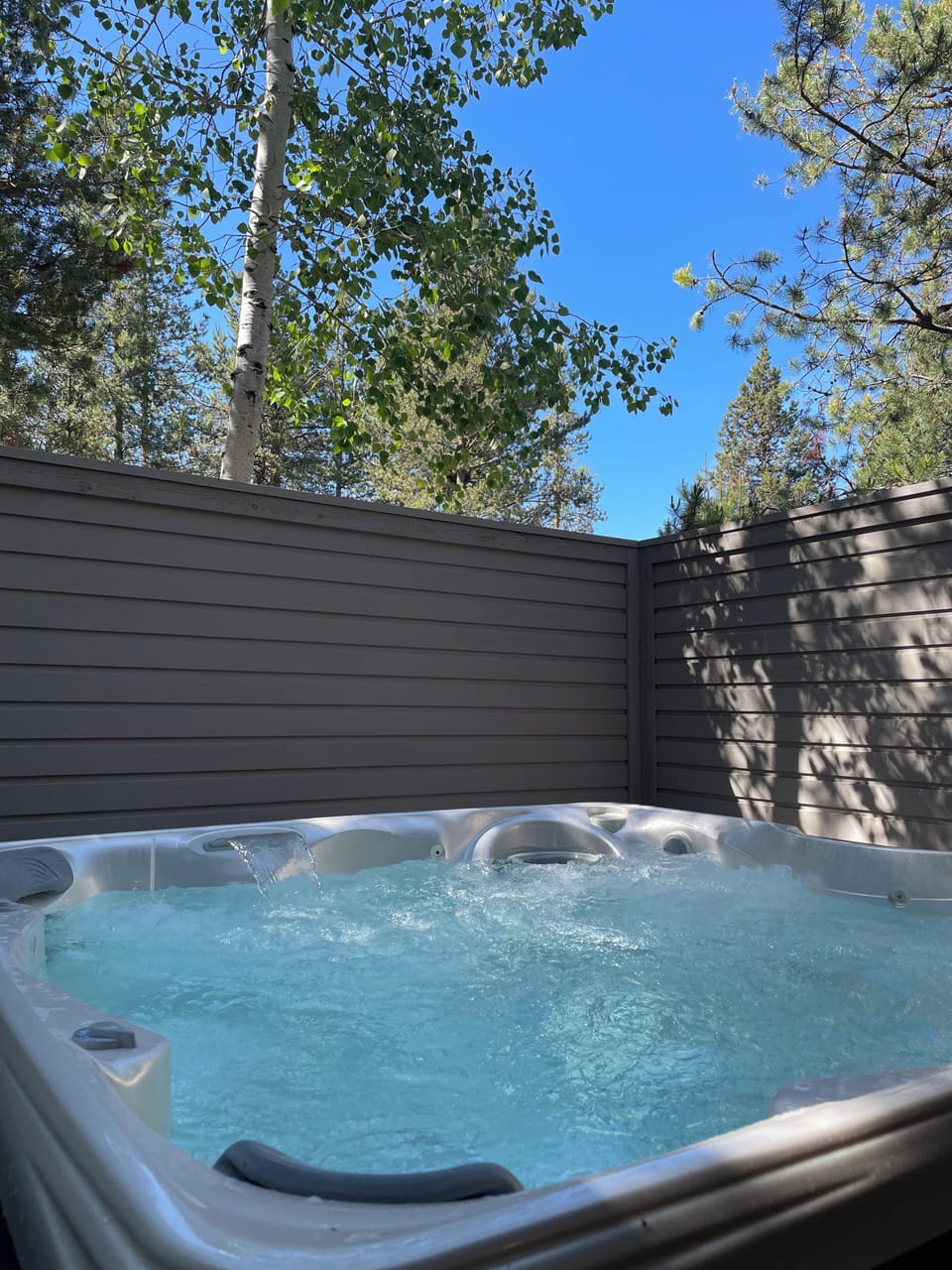 Hot tub off the game room downstairs has views of beautiful Aspen trees!