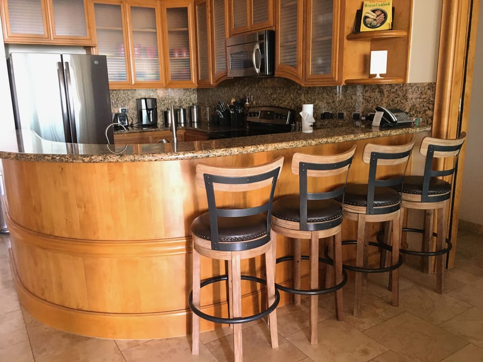 Kitchen with granite countertops, SS appliances, and well stocked for cooking