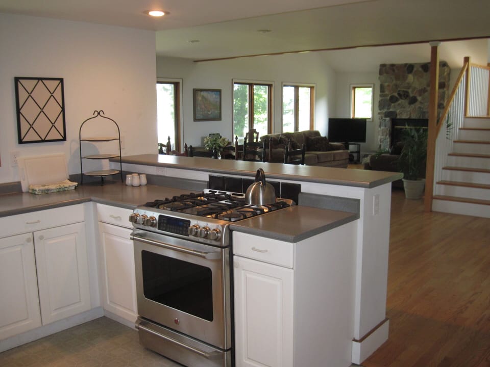 The open kitchen features a steel gas stove and lots of small touches.