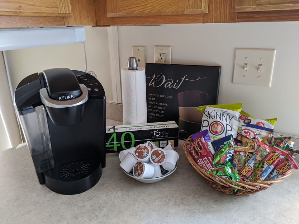 kitchen comes with Keurig and k cups, and a snack basket waiting for you