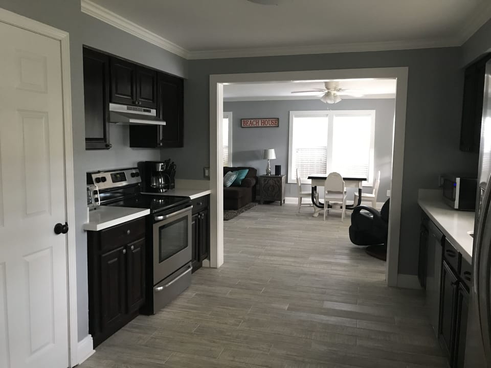 Kitchen and open floor plan to dining and living room with lots of natural light