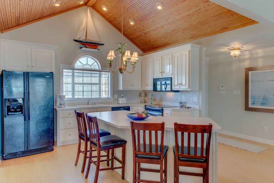 Your bright kitchen features warm wood ceilings, granite counters, and a breakfast bar where you'll love gathering for morning coffee.