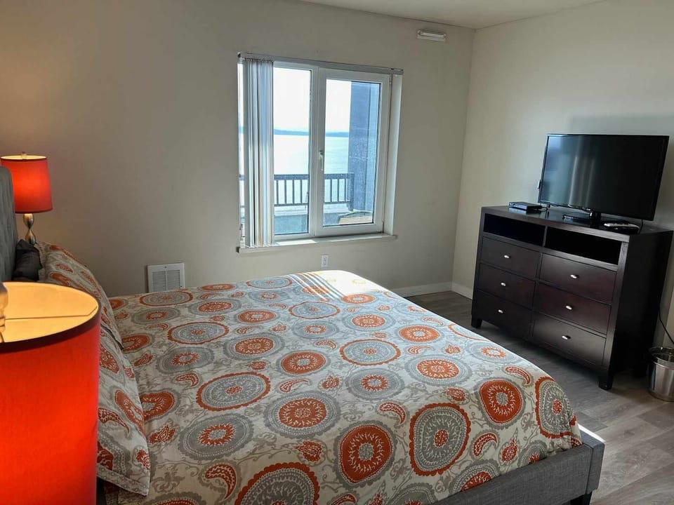 En suite with king bed, TV, water views.