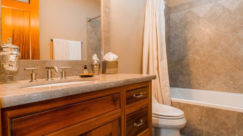 Main floor bedroom suite bath  w/ heated floors & tub/shower combo