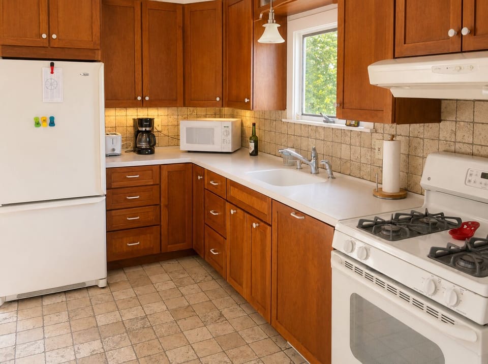 Kitchen with propane range, full size fridge, microwave, coffee maker