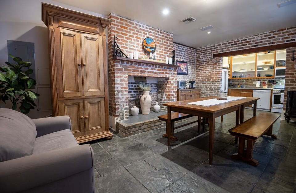 Dine in a charming space with brick walls and a rustic table