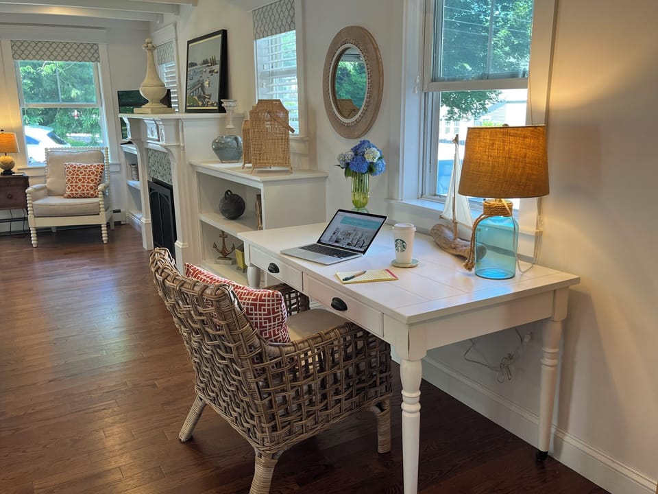 A desk area near kitchen can serve as a dining table for overflow dinner guests.