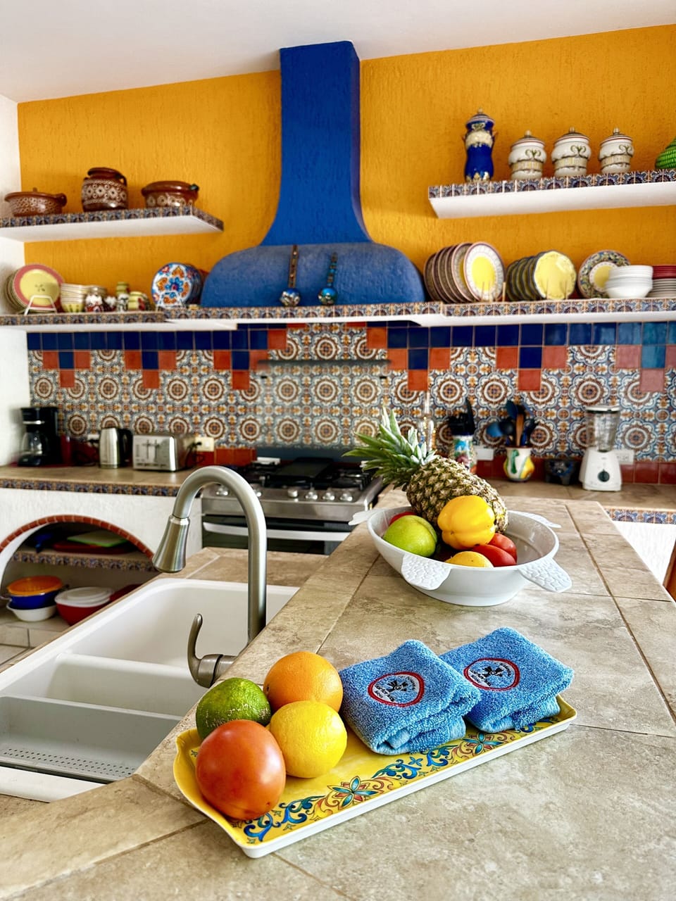 The fully equipped kitchen is decorated with talavera accents