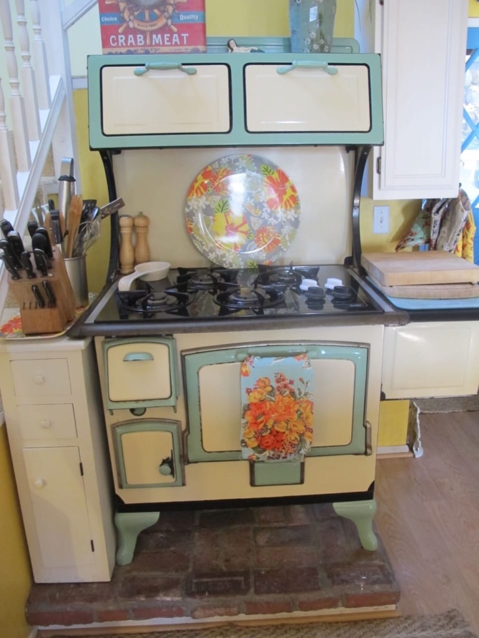 The kitchen features a working antique stove with a cooktop.