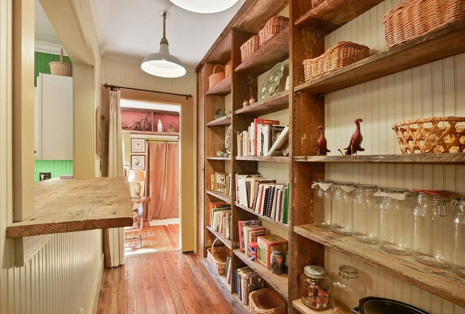 Pass through area for kitchen storage and entrance to the sunroom. 