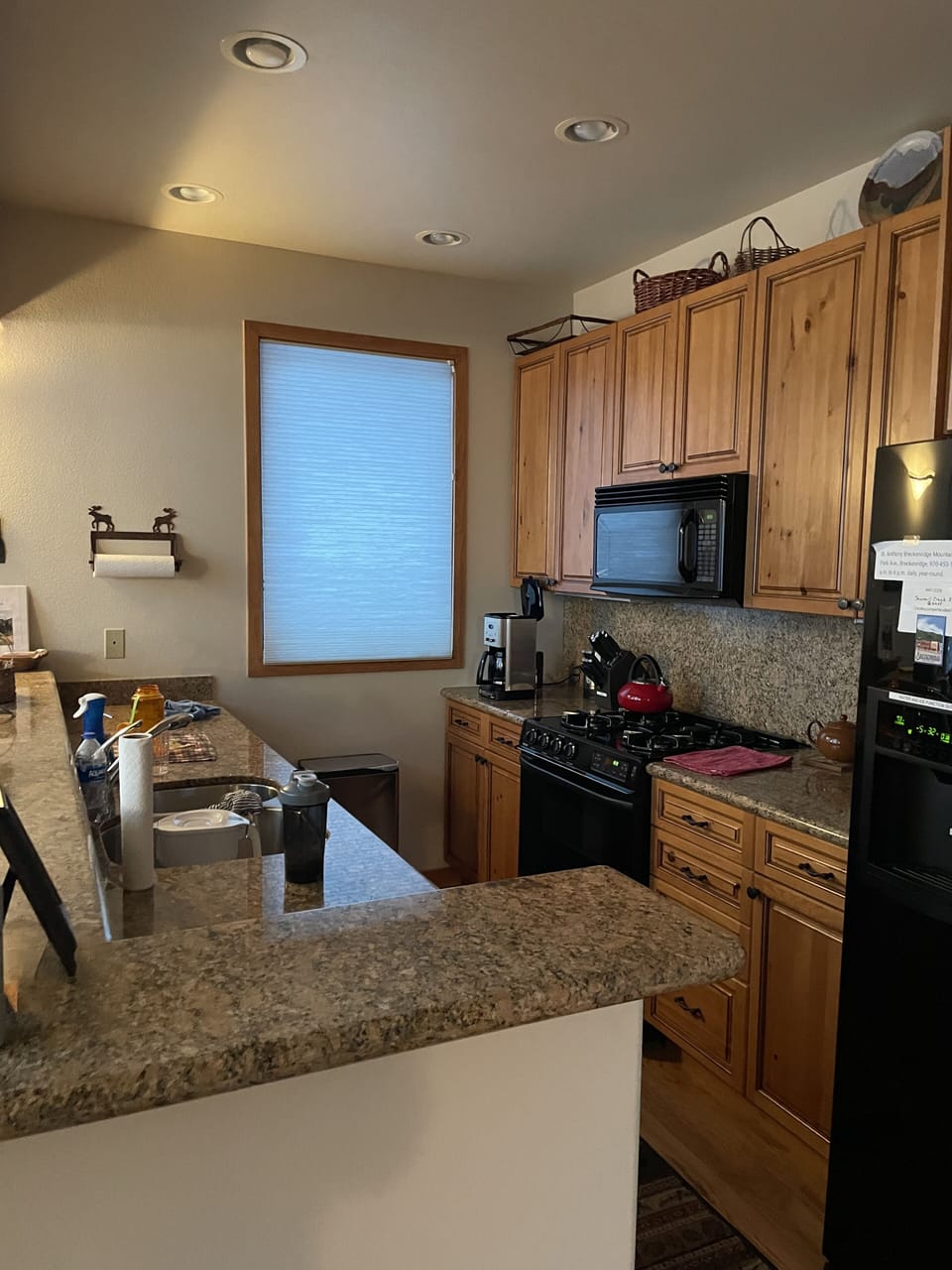 Kitchen with granite counter tops and wood floors.