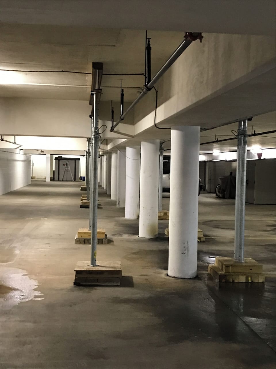 Shores install in garage beside driving area.