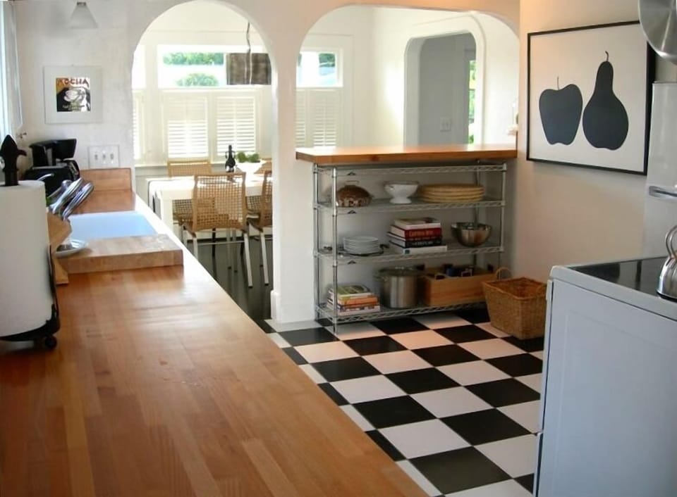 Kitchen with cookbooks, books, travel guides, maps and menus