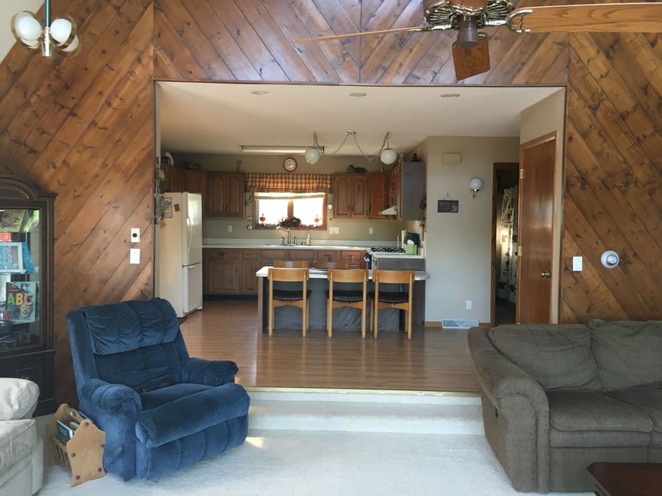 Featuring unique hand stained tongue & grove pine wall, main floor layout 