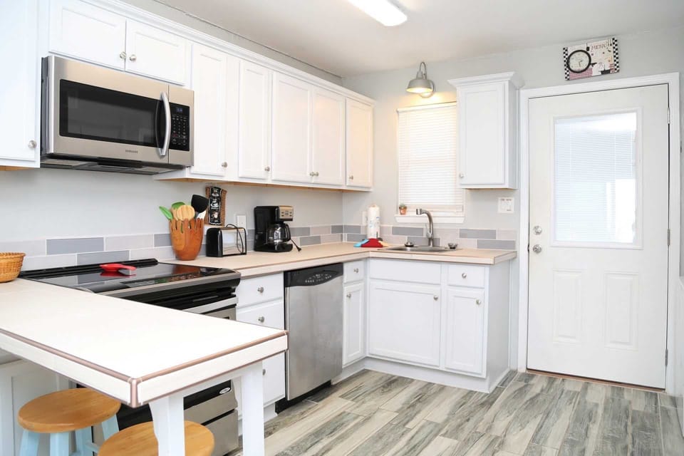 The kitchen includes new cabinets, upgraded appliances, & counter.