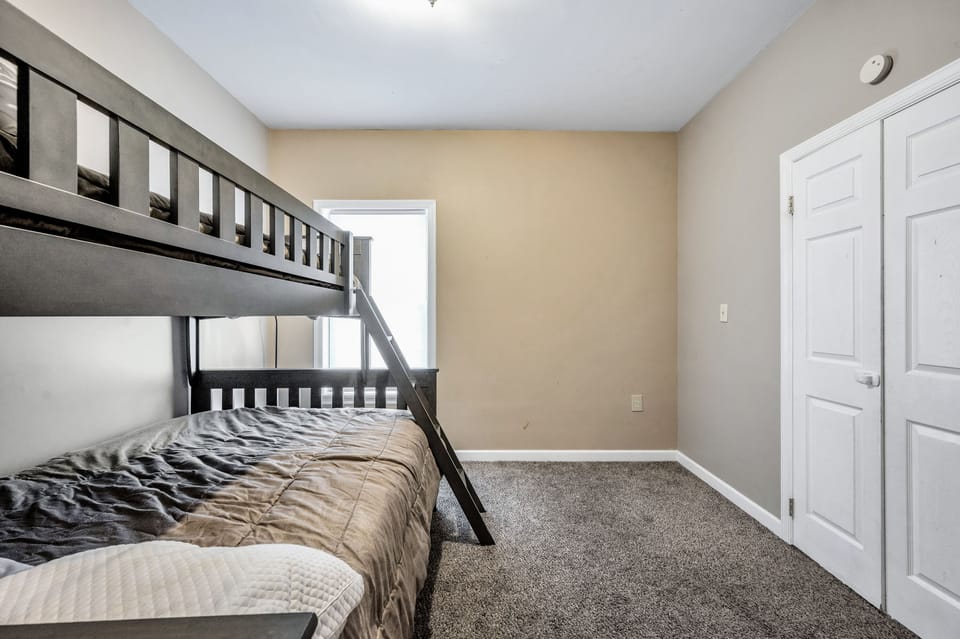 Bunk bed room downstairs with full on bottom bunk and trundle underneath