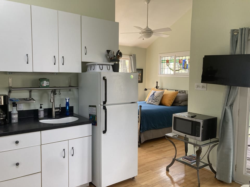 Full kitchen with fridge, microwave, oven and stove.