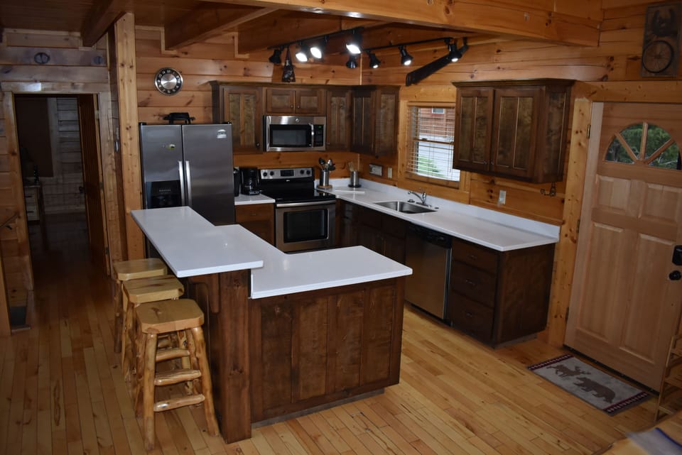 Kitchen w/ new counters, large sink, faucet, and disposal.