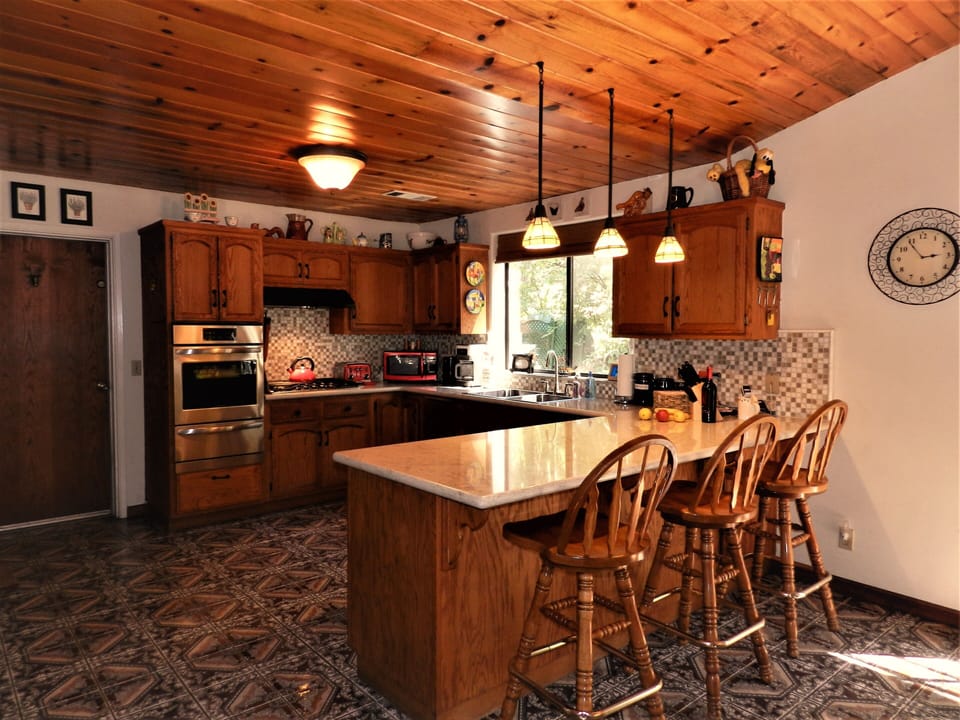Huge kitchen with peninsula and three bar stools for great meal preparation.