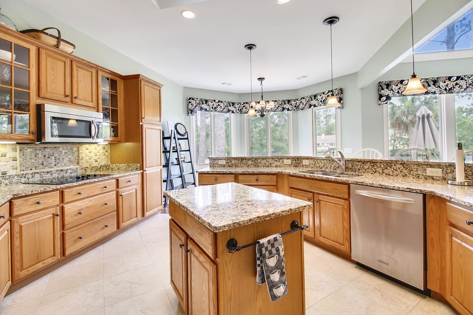 Kitchen with island and stainless steel appliances.