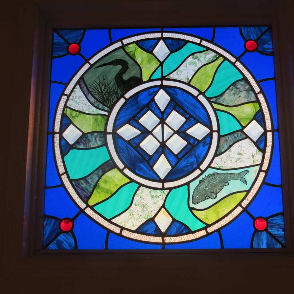 Custom stained glass window in master bedroom.
