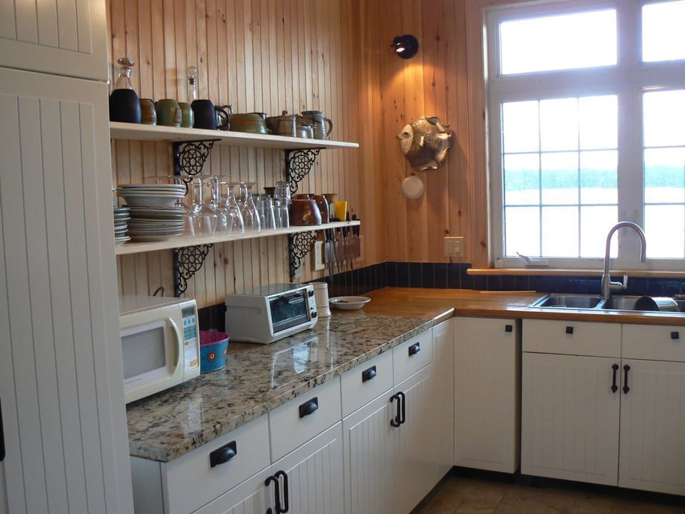 open shelving-cottage-style-kitchen, granite and wood counter tops