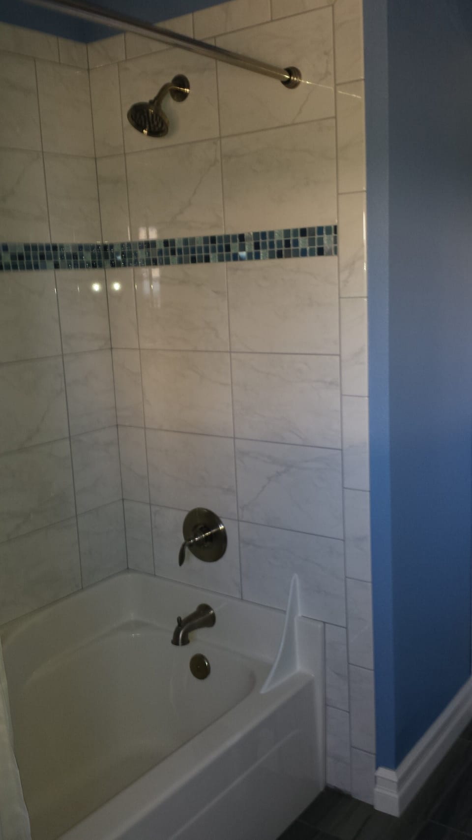 New tub, tile surround and flooring.