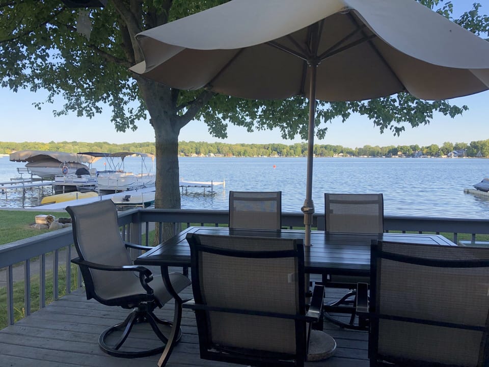 Large patio set on deck overlooking the lake