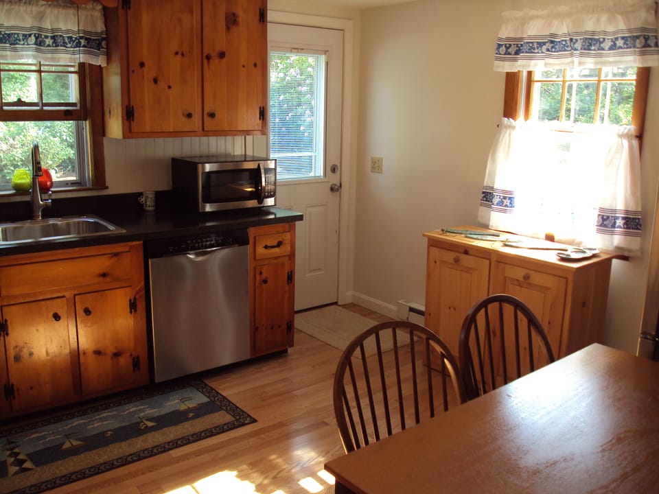 Eat in kitchen with table & 4 chairs, access to patio, gas grill & picnic table.