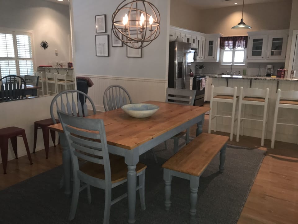 Dining room, table seats 7+ ( red stools to fill in ). Breakfast bar seats 3 