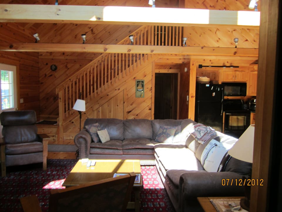 Living room. Large L-shaped couch, comfy chair, rocker