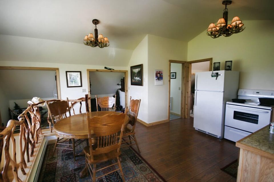 Upstairs railing and dinning area. Doors leading to bath and bedroom.