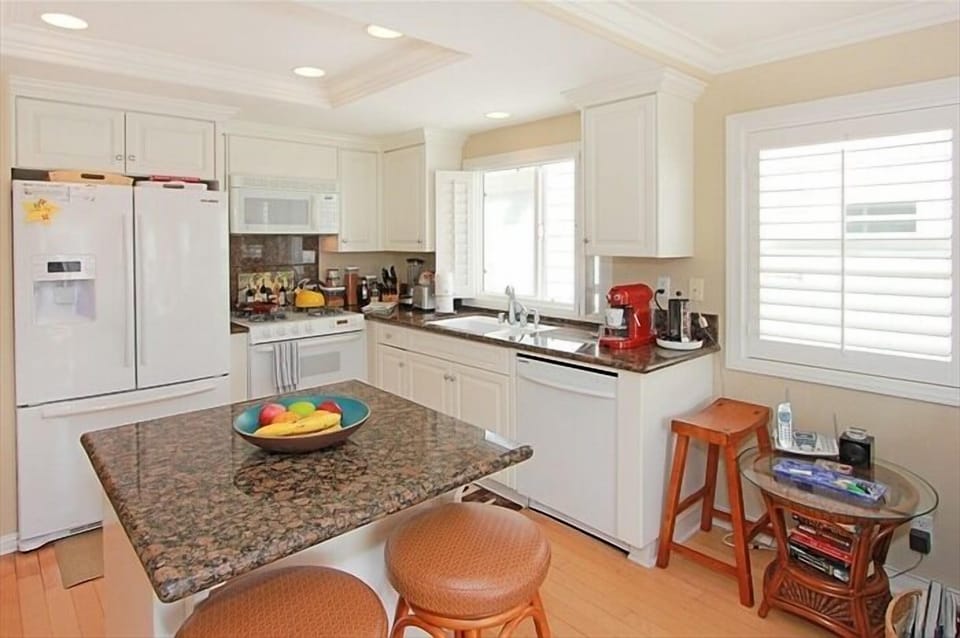 View of open plan kitchen w island & 3 Barstools, French Style Refrigerator