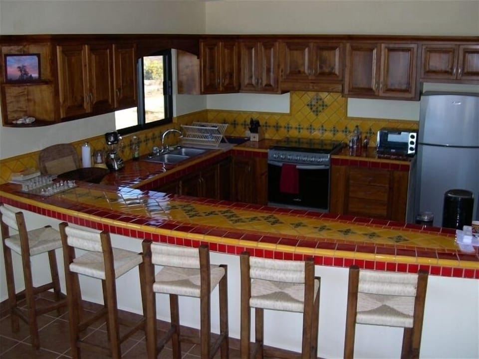 Ground floor suite kitchen accented with Mexican tile.
