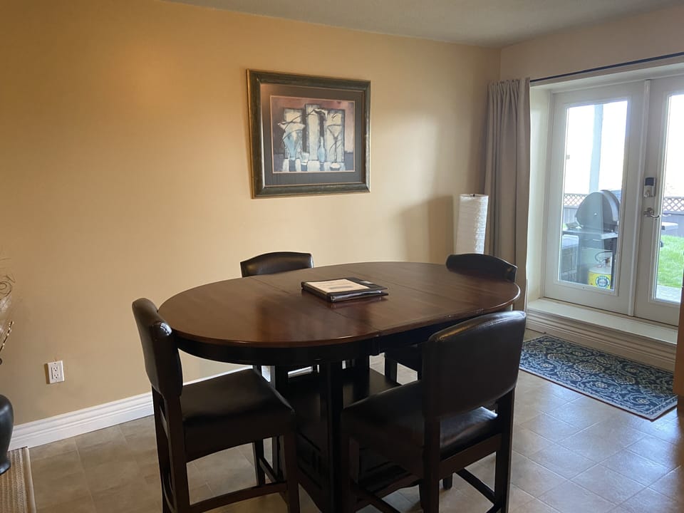 In kitchen dining, double glass doors open to the covered private patio.