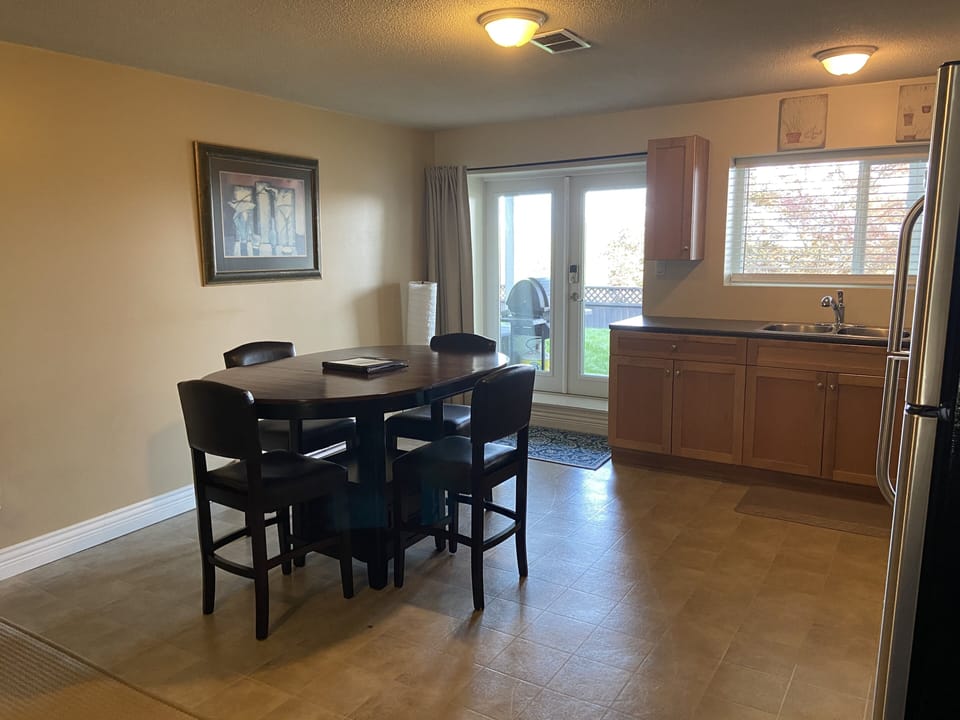 In kitchen dining, double glass doors open to the covered private patio.