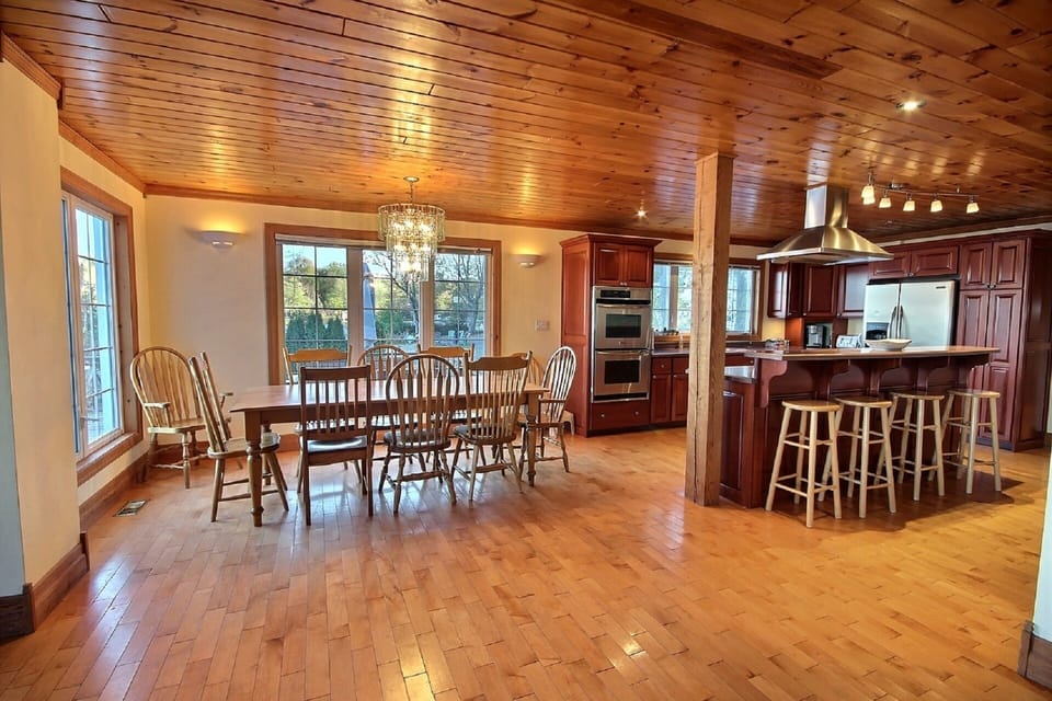 Fully stocked kitchen with double oven, place settings, pots, and pans