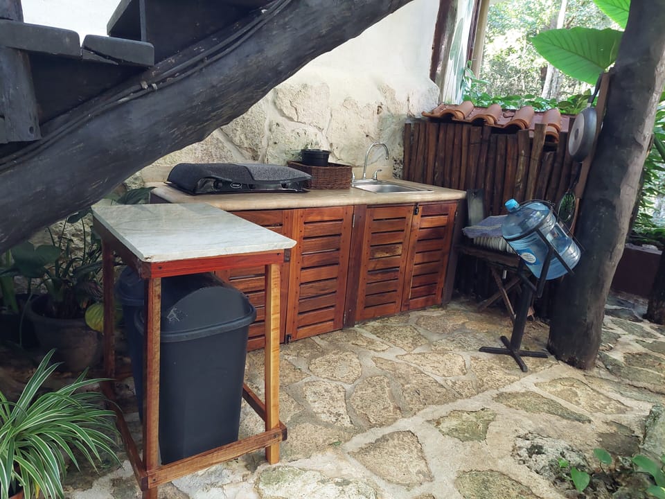 outdoor kitchen with gas stove, plates, silverware, pots, pans, coffee pot, etc.