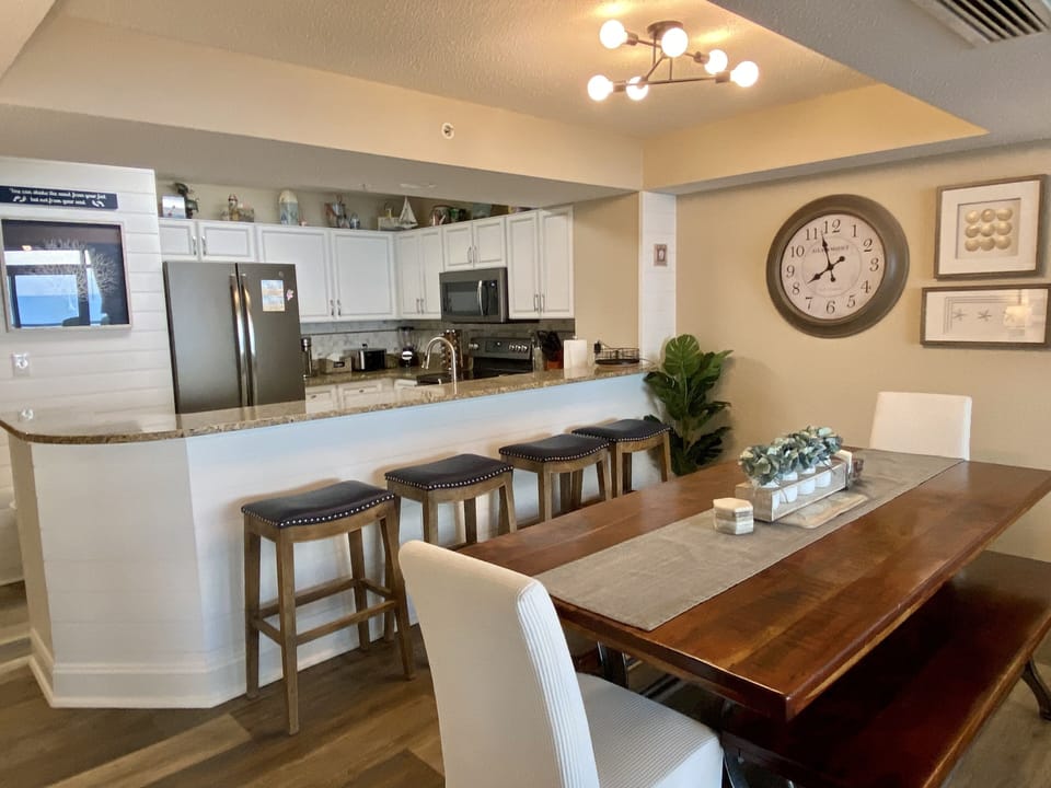 The dining room seats 12; 8 at the table and 4 at the breakfast bar.